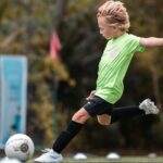 A child strikes a football at Kuramathi Maldives