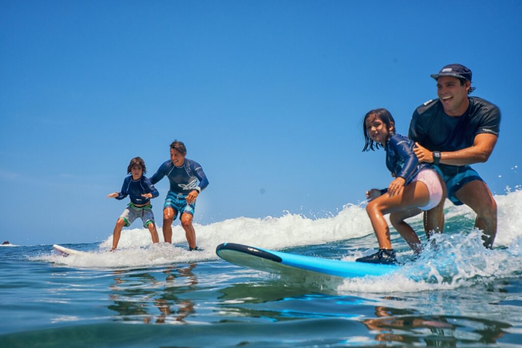 Kids learn to surf at Four Seasons Maldives